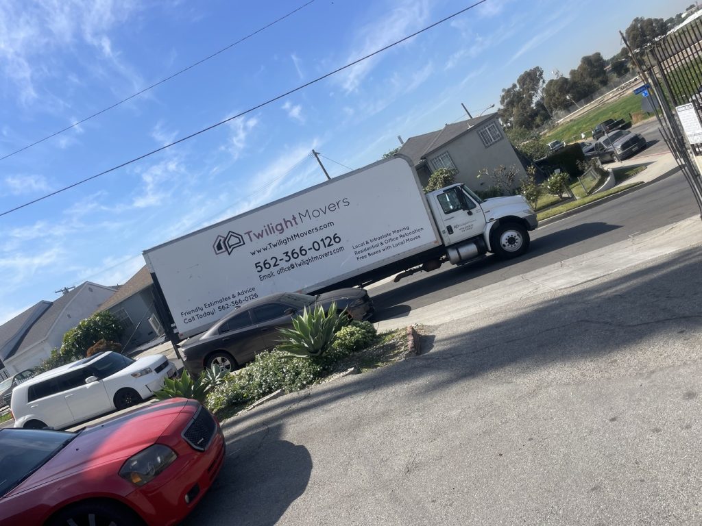 Long Beach moving: movers loading a truck near the coast