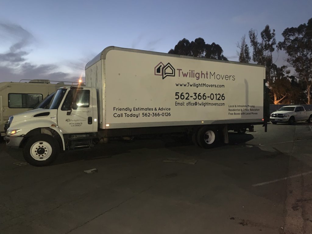 Twilight Movers team preparing boxes for loading in a Long Beach home
